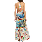 Woman wearing a colorful patterned dress with a white background