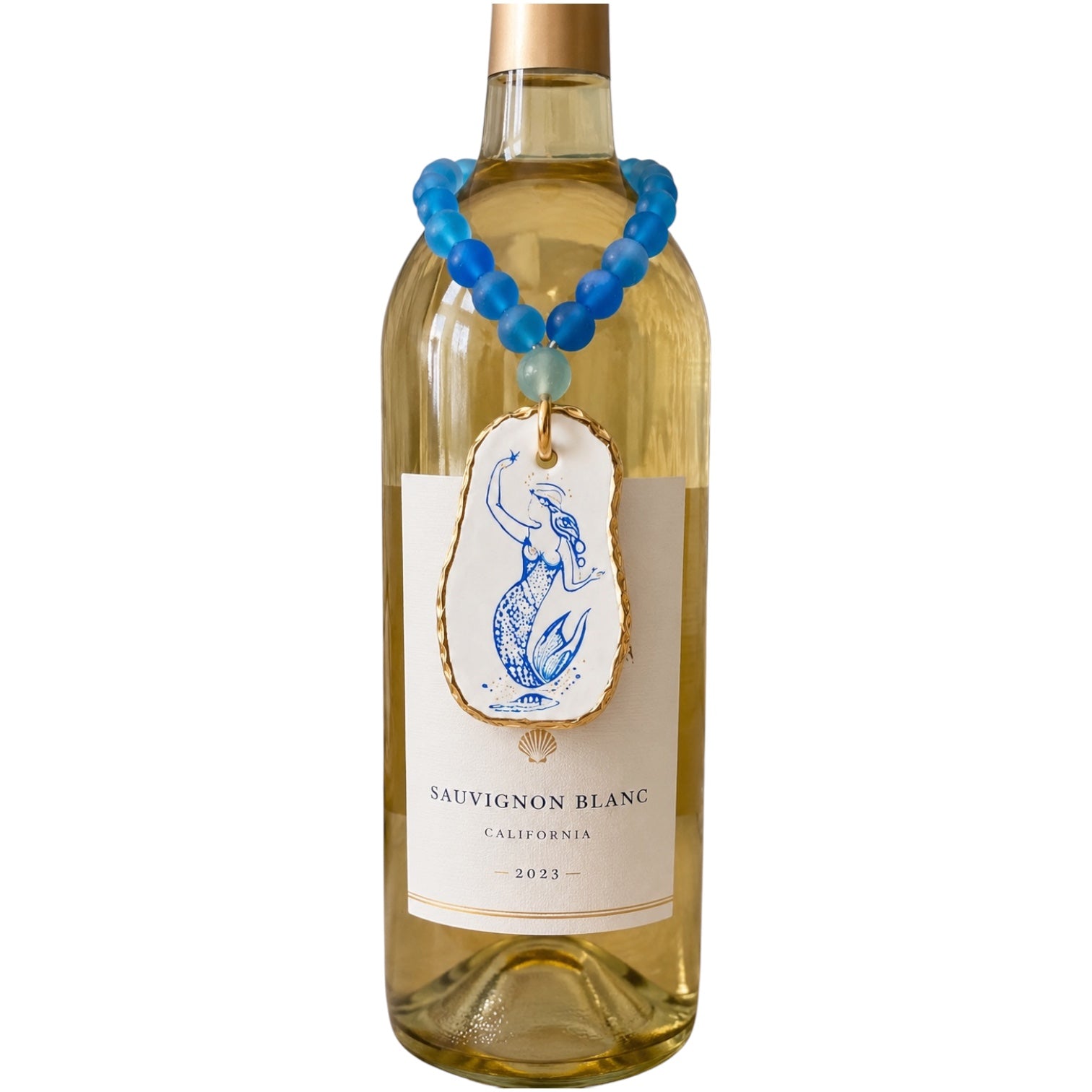 A bottle of Sauvignon Blanc wine with a decorative blue beaded necklace and pendant hanging from the neck, shown on a plain white background.