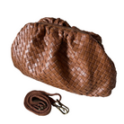 Cognac woven handbag with a matching strap on a white background