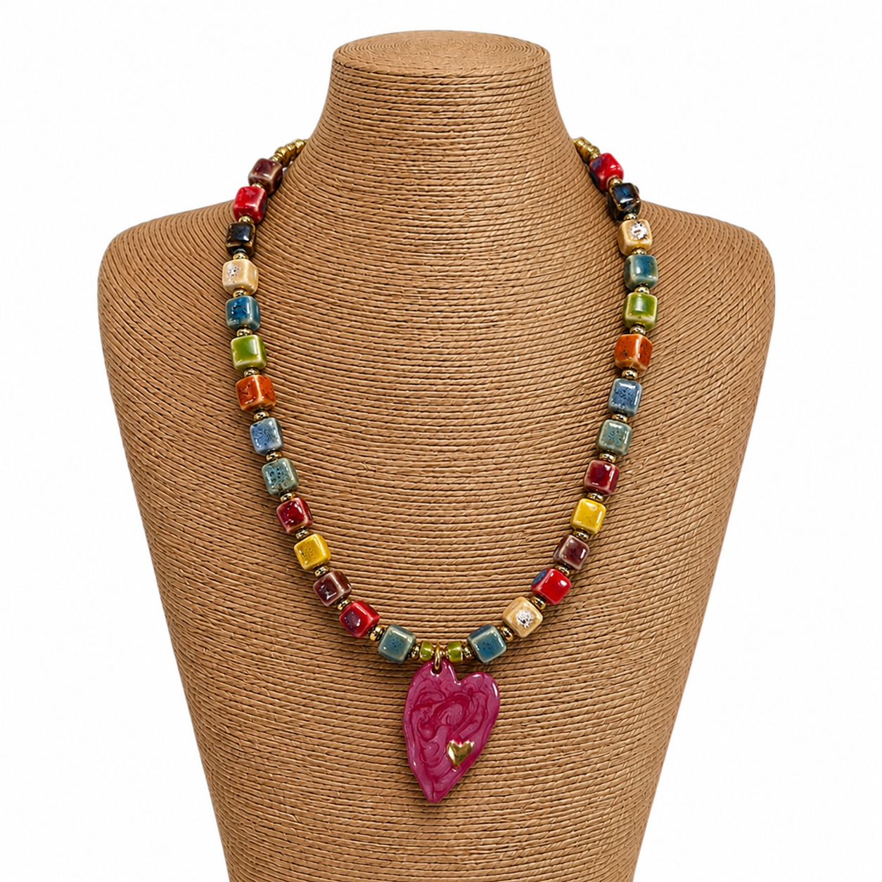 Colorful beaded necklace with a heart-shaped pendant on a mannequin bust.