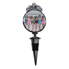 A novelty wine bottle stopper featuring a circular printed graphic of the band Girls Like Girls with the text 'Girlsfriends Matter' and a silver metallic top and pointed black-and-silver stopper base.