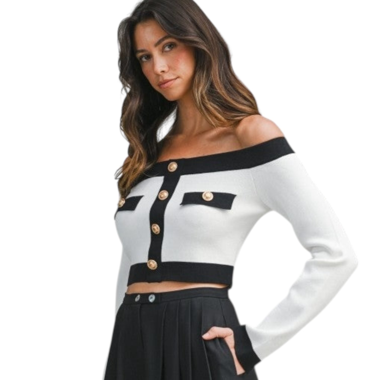 Woman wearing a black and white off-shoulder top with button details on a white background