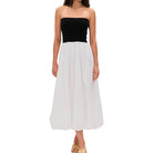 Woman wearing a black strapless dress on a white background