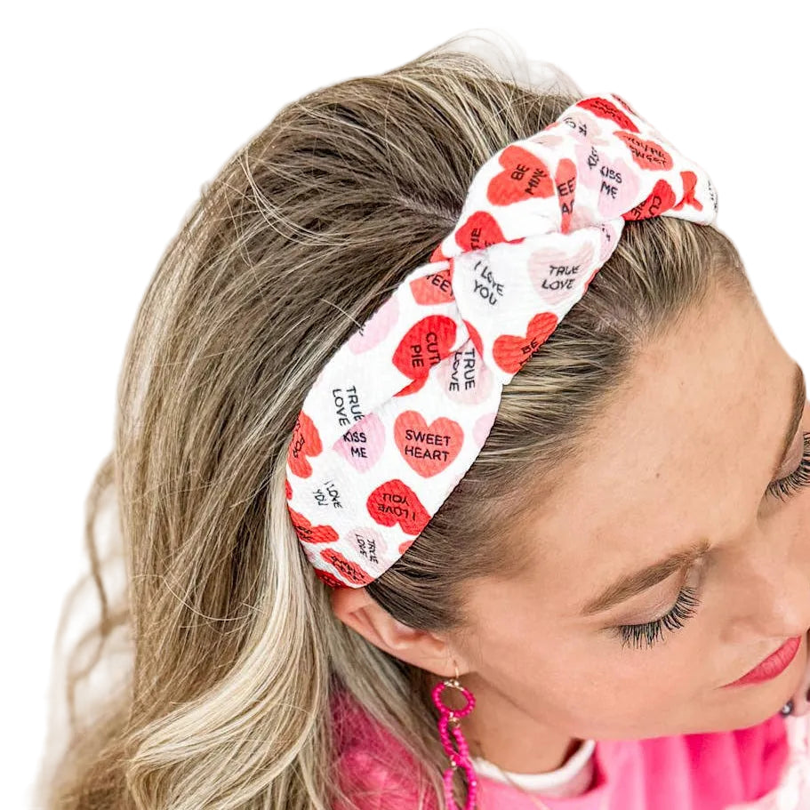 Woman wearing a headband featuring heart designs.
