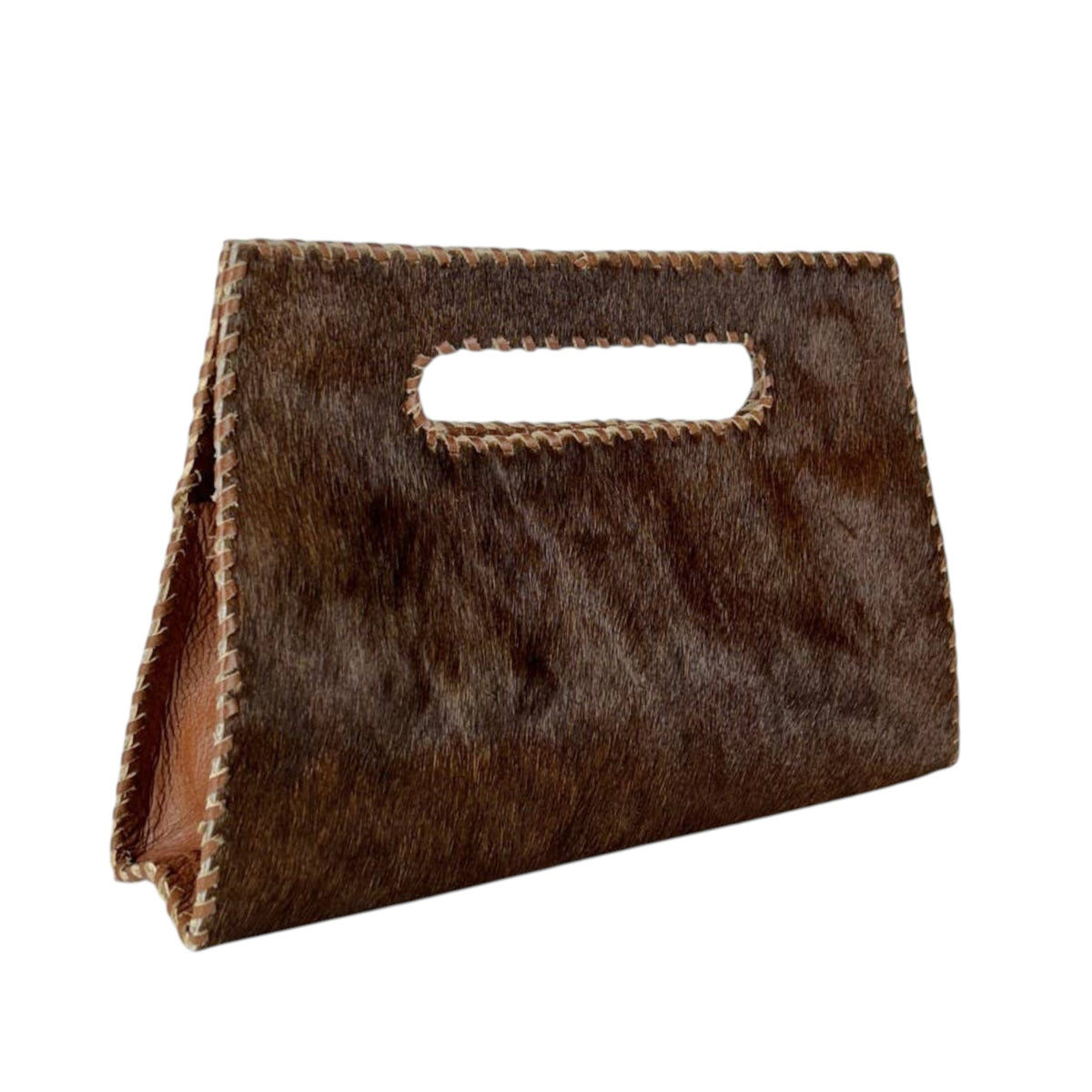 A brown cowhide handbag with a cutout handle and braided leather trim, shown on a plain white background.
