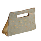 A rectangular handbag made of textured cowhide with a cutout handle, featuring a speckled pattern of metallic gold spots on a light gray base, with visible whipstitching along the edges.