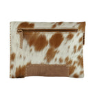 A small zippered clutch or wallet in cowhide with a brown and white mottled pattern, featuring a tan leather patch and zipper pull on a plain white background.