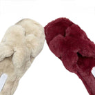 Two pairs of fuzzy slippers, one beige and one red, on a white background.