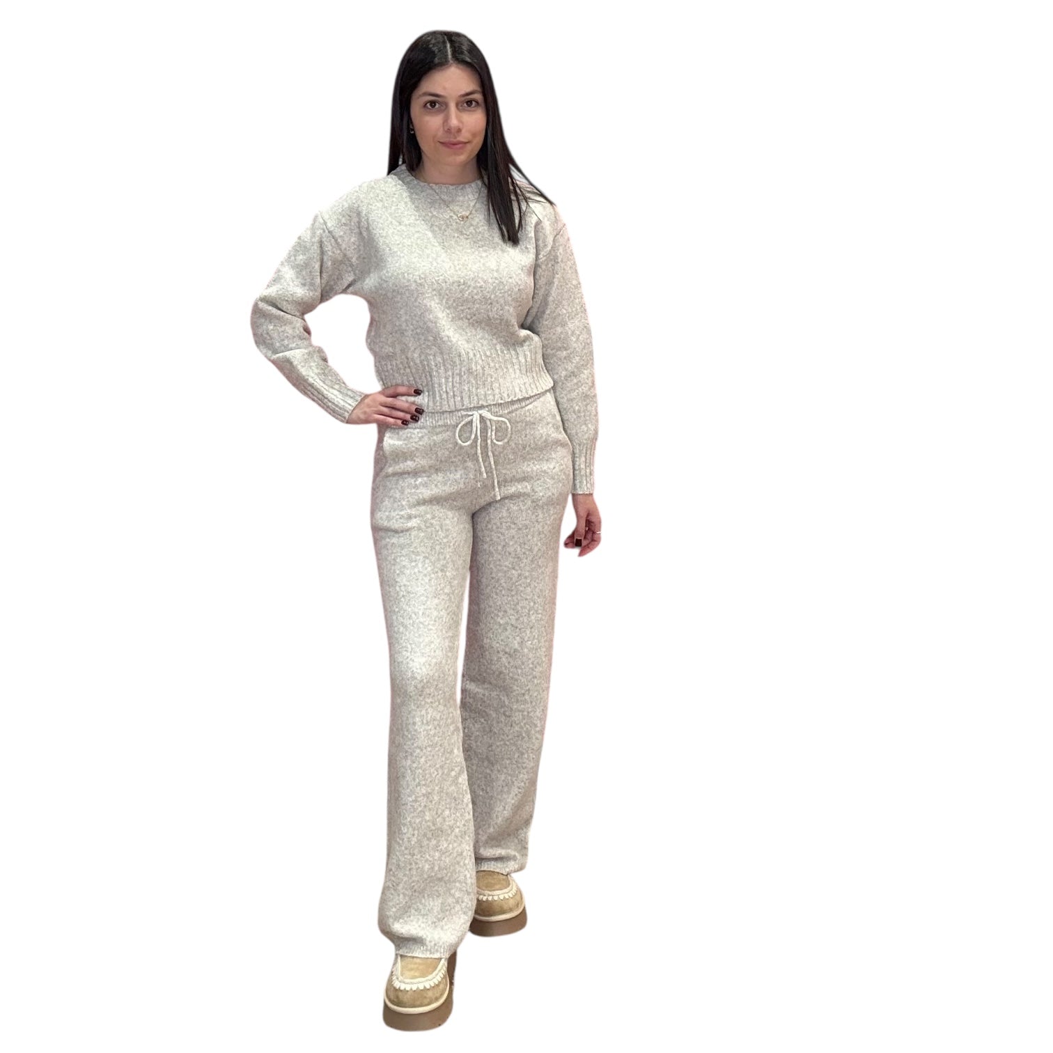 Woman wearing a oat knit outfit on a white background