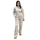 Woman wearing a oat knit outfit on a white background