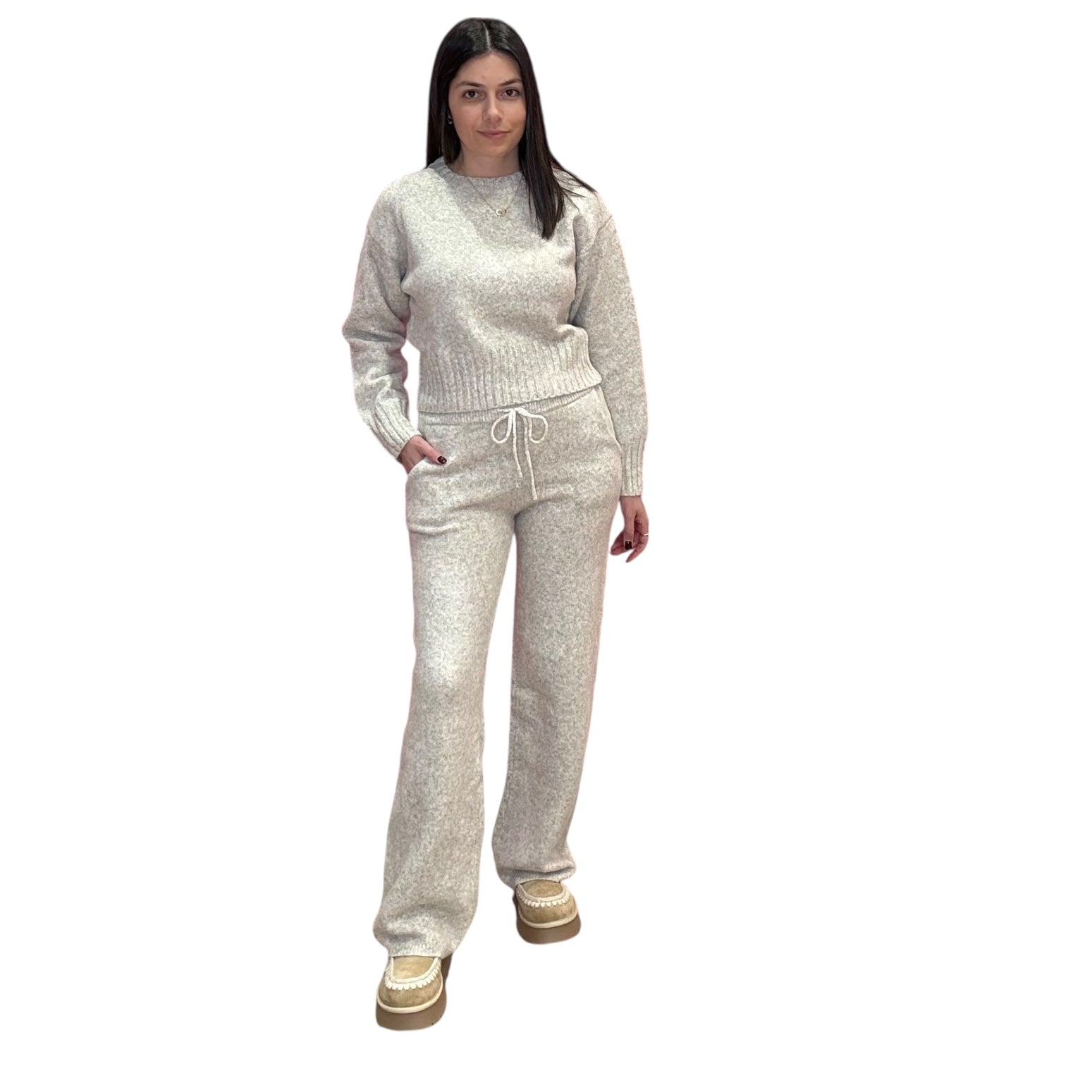 Woman wearing a oat knit outfit on a white background