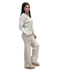 Woman wearing a oat knitted outfit on a white background