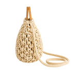 Beige woven handbag with a strap on a white background