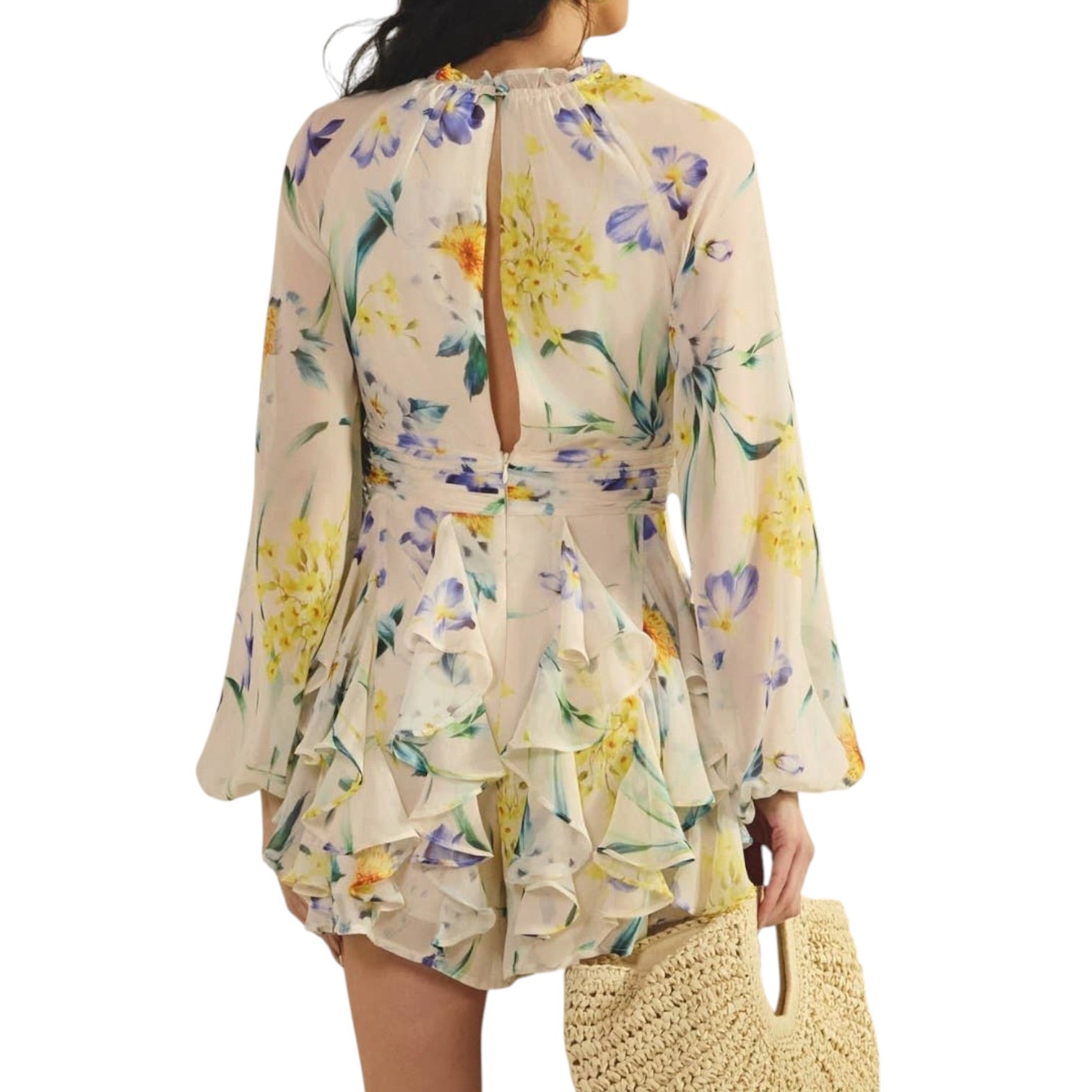 Woman wearing a floral romper with a white background