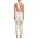 Beige jumpsuit with lace details on a white background