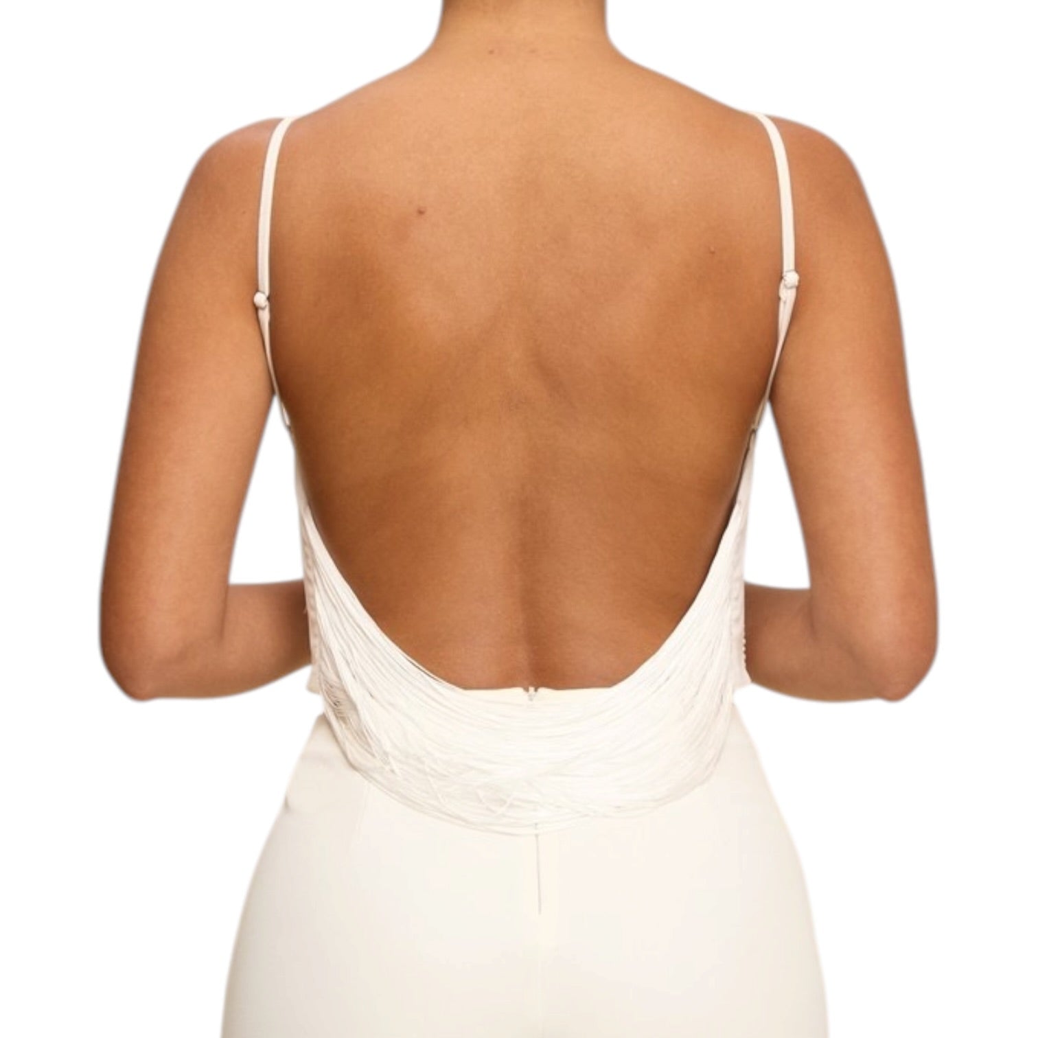 Back view of a person wearing a white dress with thin straps on a white background