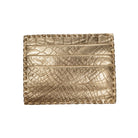 A gold metallic leather card holder with a crocodile-embossed texture and stitched edges, shown flat against a white background.
