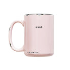 Pink mug with the word 'cunt' printed on it against a white background