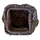 Brown woven leather handbag on a white background