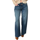 Blue jeans worn by a person on a white background