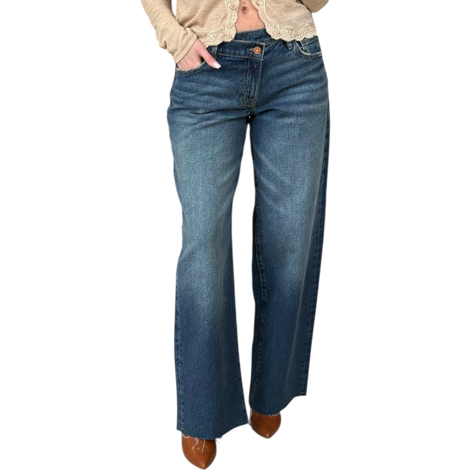 Blue jeans worn by a person on a white background