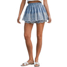 Blue lace shorts worn by a person on a white background