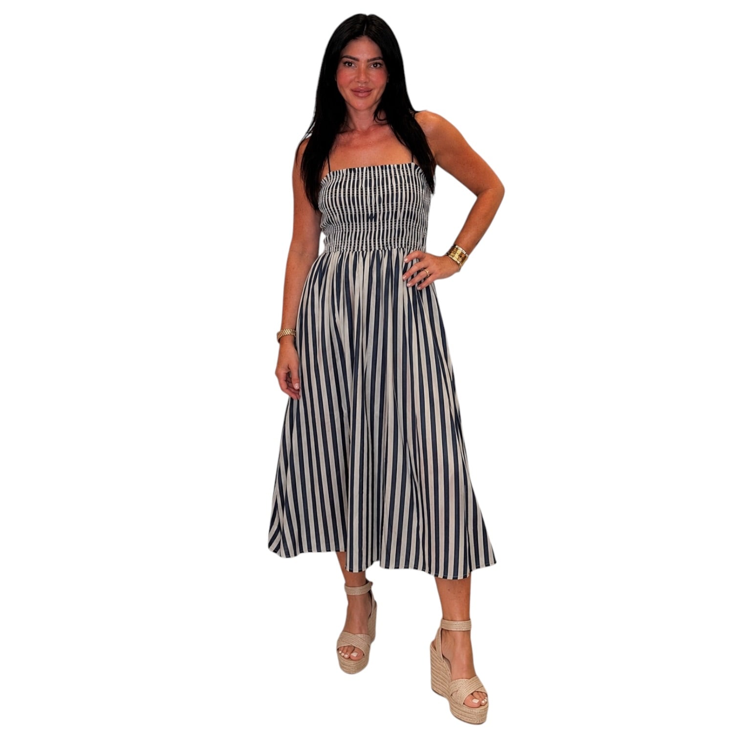 Woman wearing a denim and white striped dress on a white background