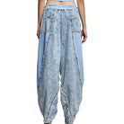 Light blue distressed denim pants on a white background