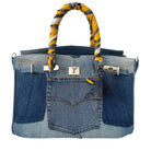 Denim handbag with a colorful handle on a white background