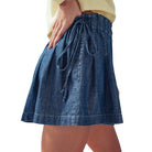 Blue denim skirt with a tie waist on a white background