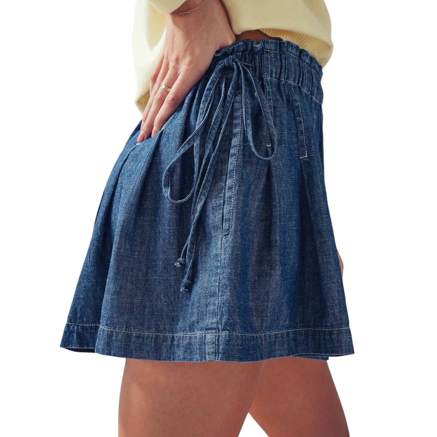 Blue denim skirt with a tie waist on a white background