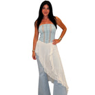 Woman wearing a strapless top and jeans with a white overlay on a white background