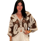 Woman wearing a brown and beige patterned cardigan on a white background