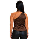 A woman viewed from the back wearing a brown satin one-shoulder top and black faux-leather pants against a plain white background.
