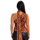 A woman shown from the back wearing a brown halter-style top with a white spotted pattern and a matching scarf draped over her shoulders, paired with black pants, against a plain white background.