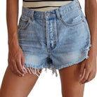 Denim shorts with frayed hem on a white background