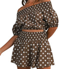 model wearing brown and white polka dot bubble tube top and shorts set