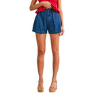 Person wearing blue denim shorts on a white background