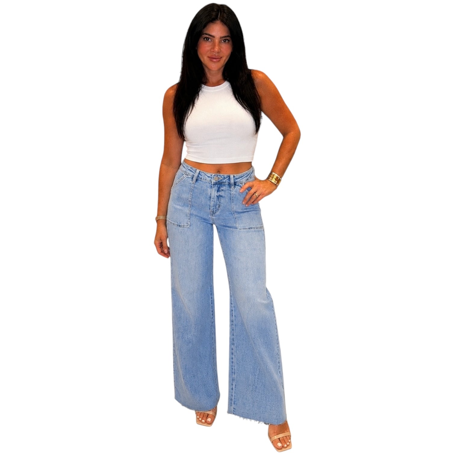 Woman wearing a white top and light blue jeans on a white background
