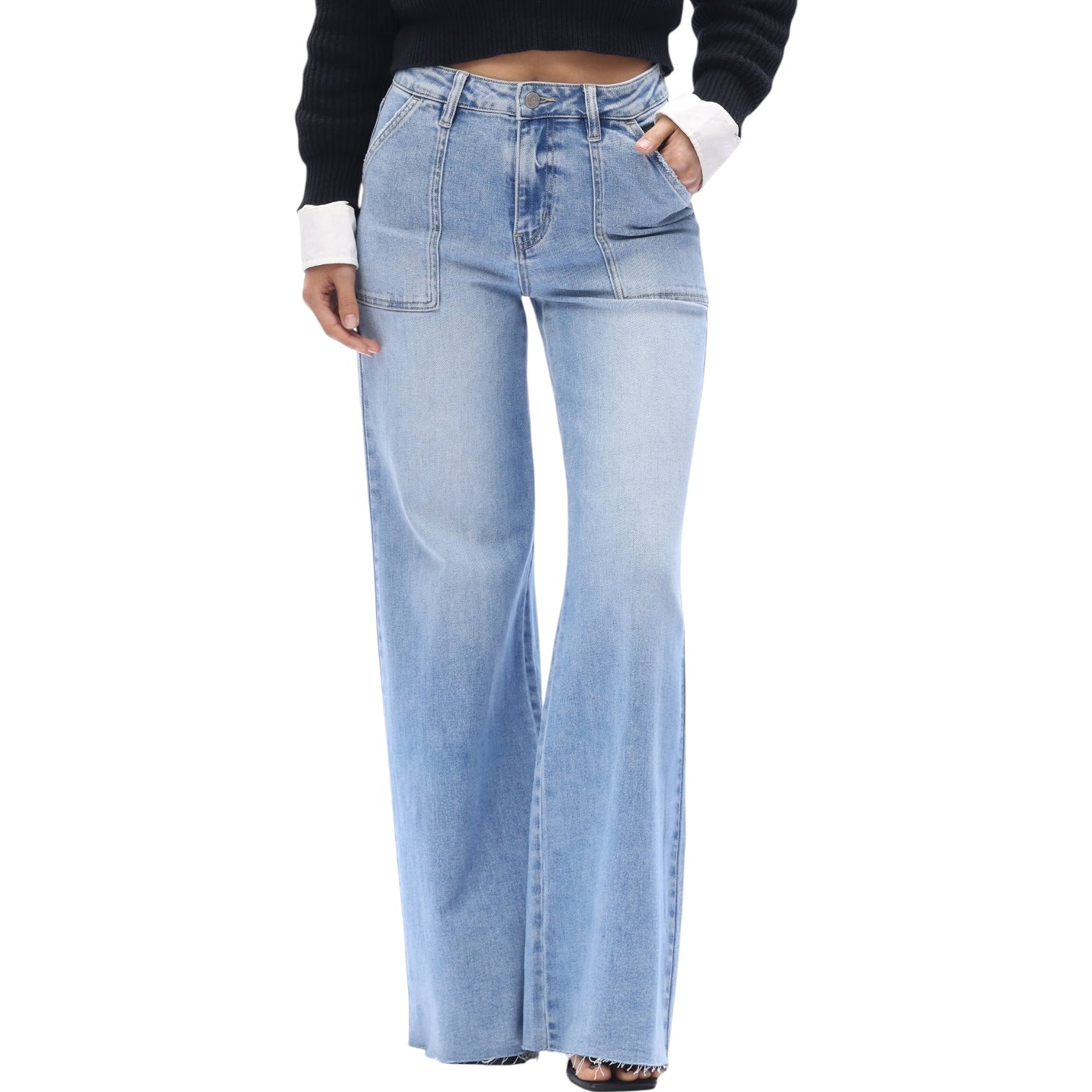 Light blue flared jeans worn by a person on a white background