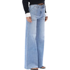 Light blue jeans worn by a person on a white background