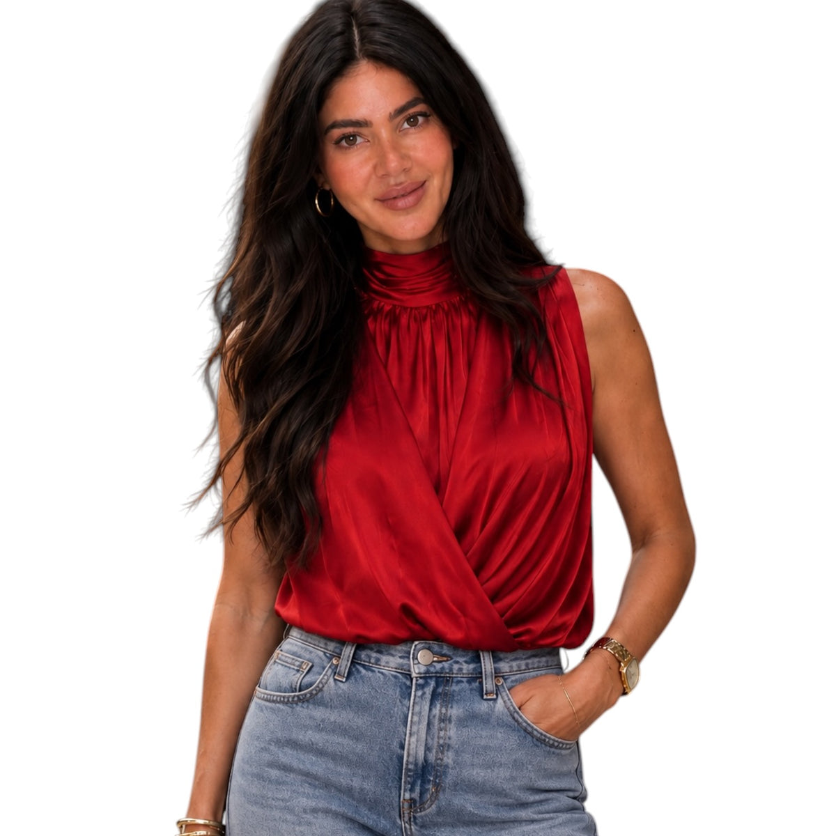 A woman wearing a sleeveless, high-neck red satin blouse with a twisted front detail, paired with light-wash blue jeans, set against a plain white background.