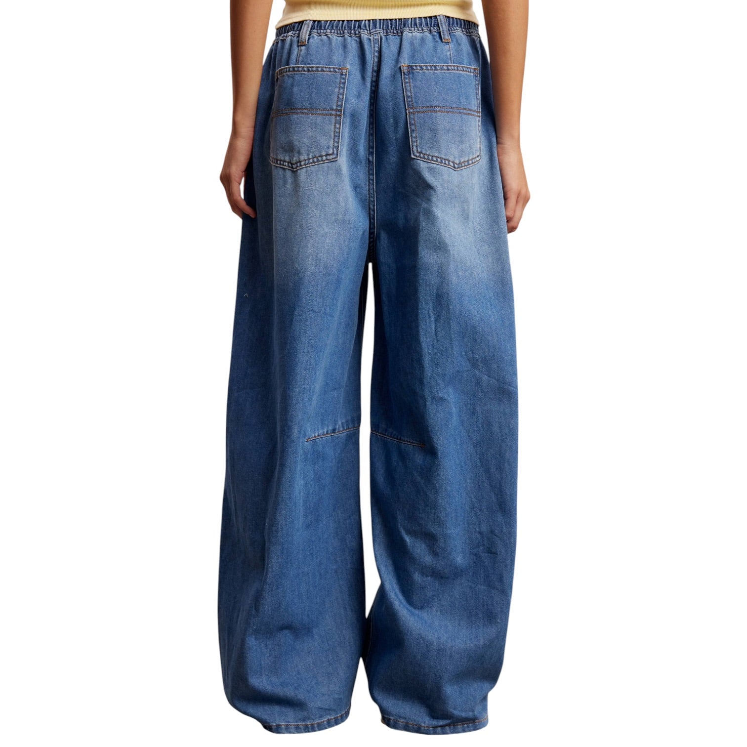 Wide-leg blue jeans on a white background