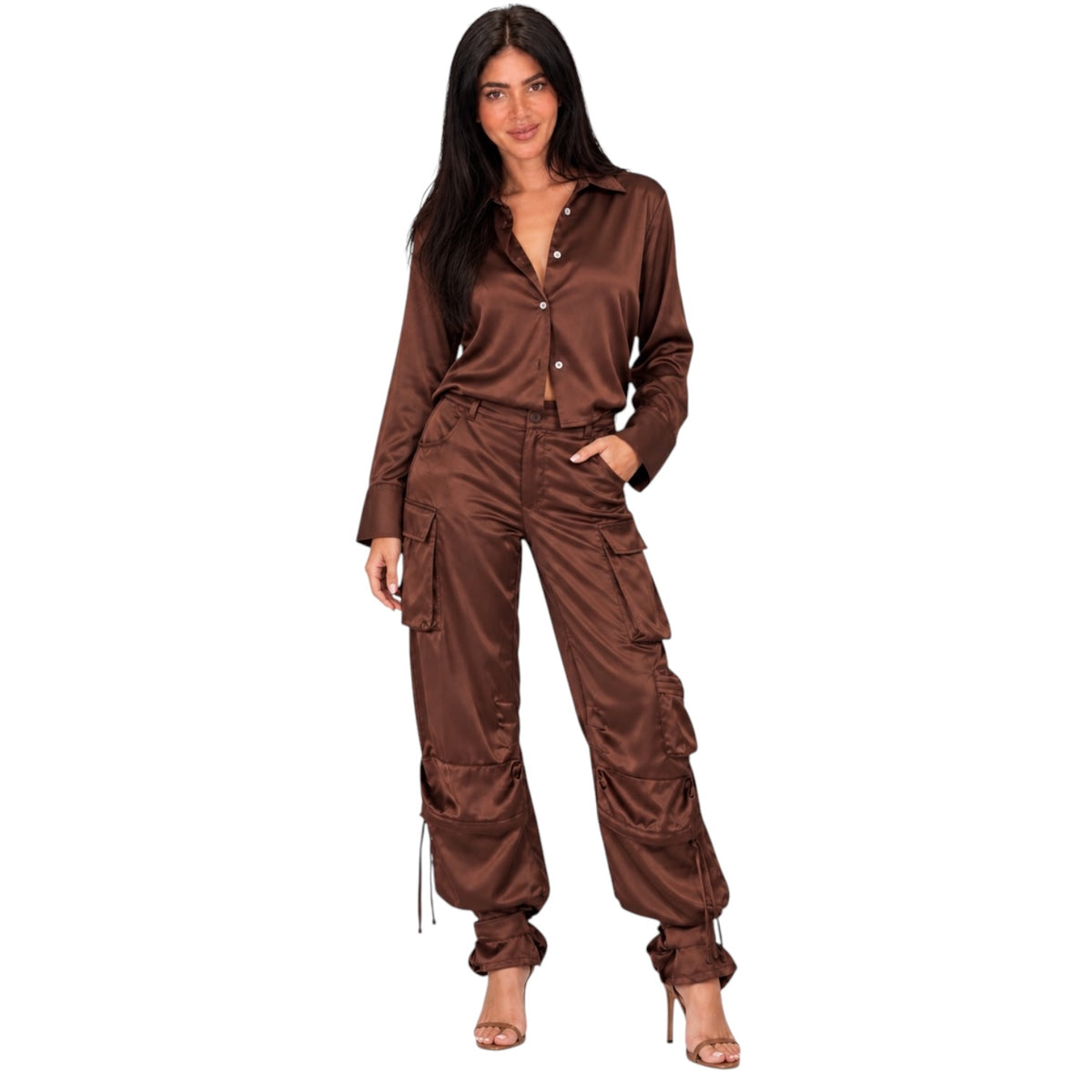 A woman modeling a matching brown satin button-up shirt and cargo pants set against a plain white background.