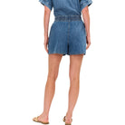Denim shorts worn by a person on a white background