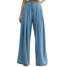 Blue wide-leg jeans worn by a person on a white background