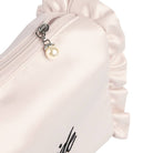 Close-up of a white pouch with a pearl charm on a white background