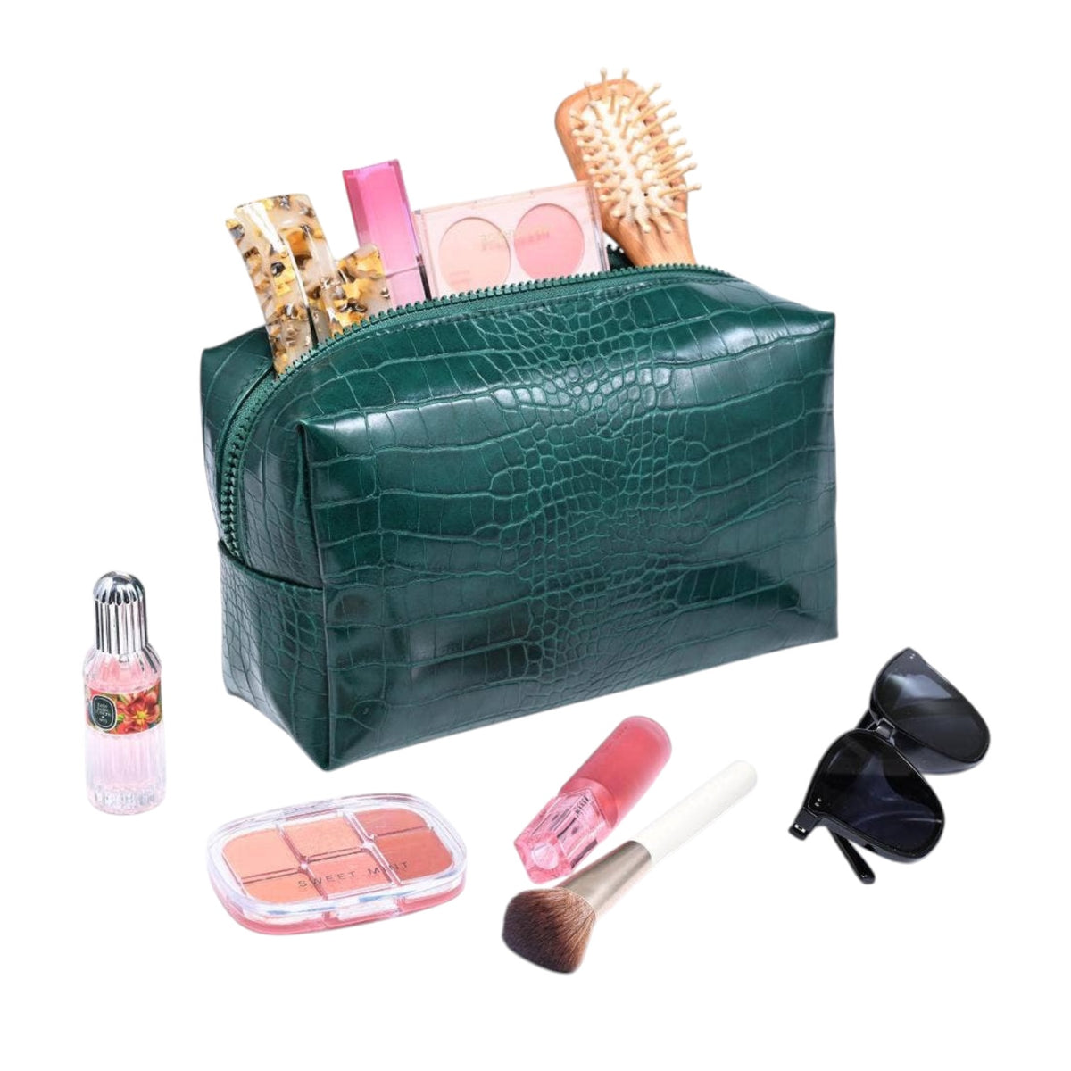 A dark green crocodile-embossed zippered cosmetic bag shown open with makeup items inside and several matching cosmetics arranged around it on a white background.