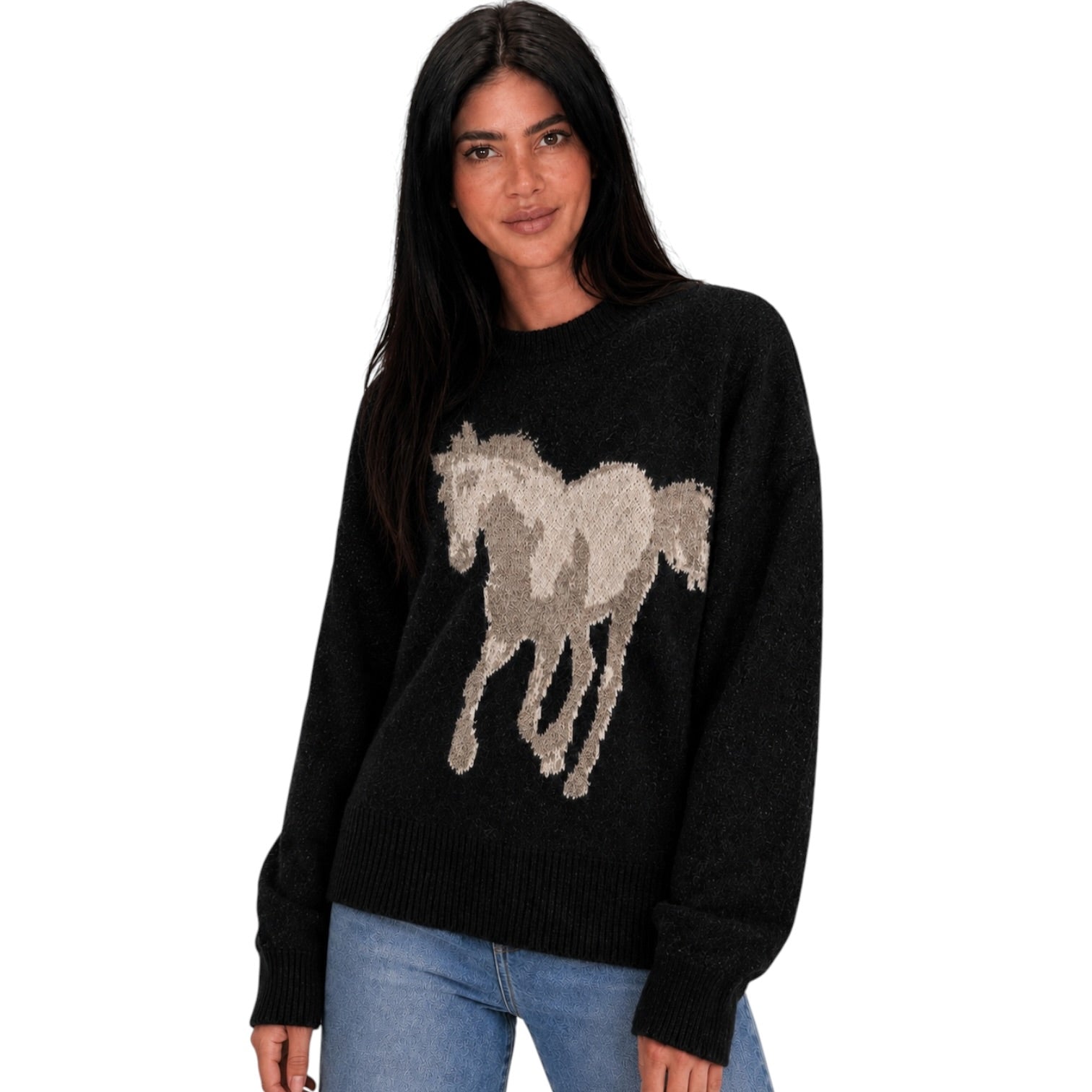 A woman modeling a black knit sweater featuring a large beige and gray horse motif across the chest, paired with blue jeans against a plain white background.