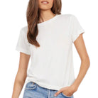 Woman wearing a plain white t-shirt and blue jeans on a white background